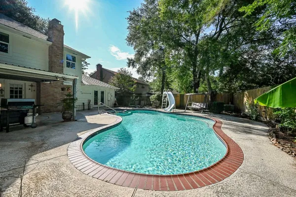 swimming pool with outdoor seating and plants