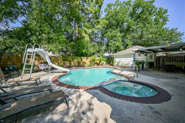 a view of a swimming pool with a outdoor seating