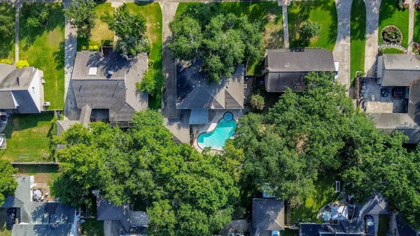 an aerial view of multiple houses with yard