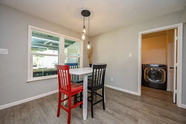 a view of a dining room with furniture window and wooden floor