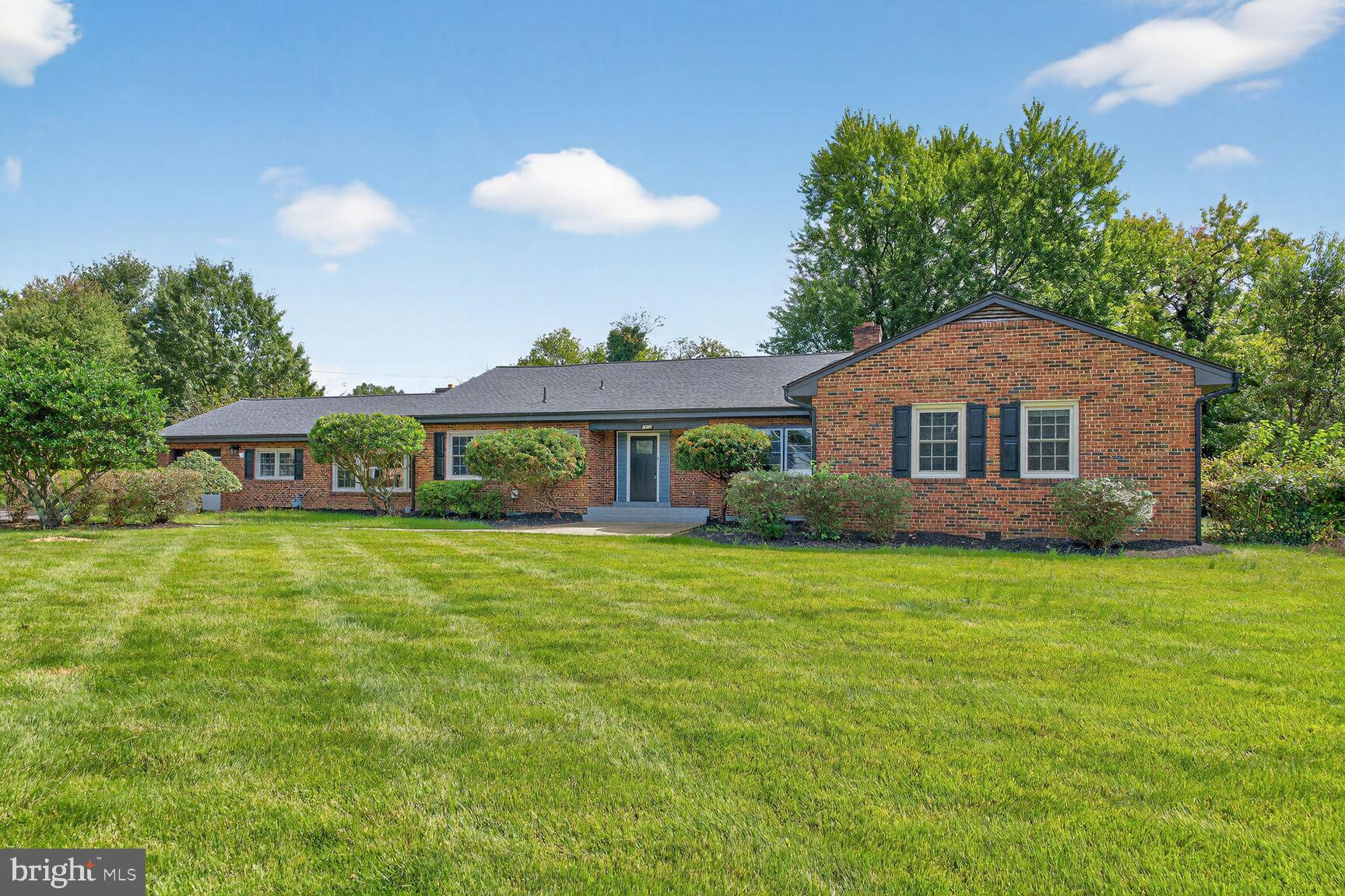 3612 Swann Road Suitland, MD 20746 - Photo 1 of 30 a front view of a house with a garden