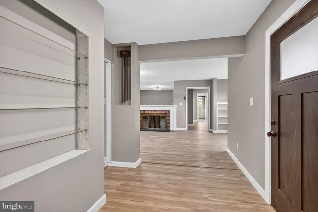 a view of a hallway view with wooden floor and staircase