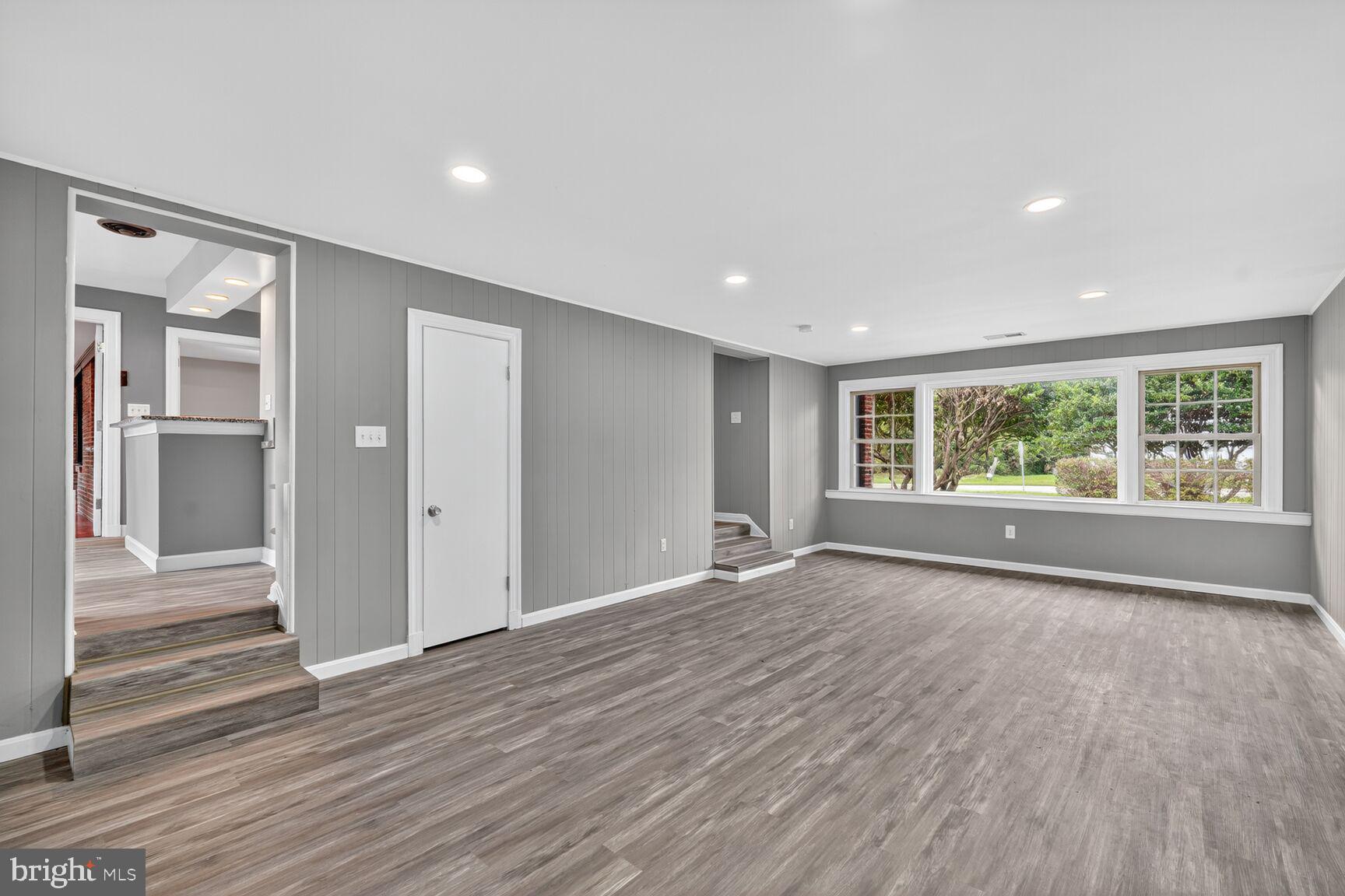 3612 Swann Road Suitland, MD 20746 - Photo 5 of 30 a view of an empty room with wooden floor and a window