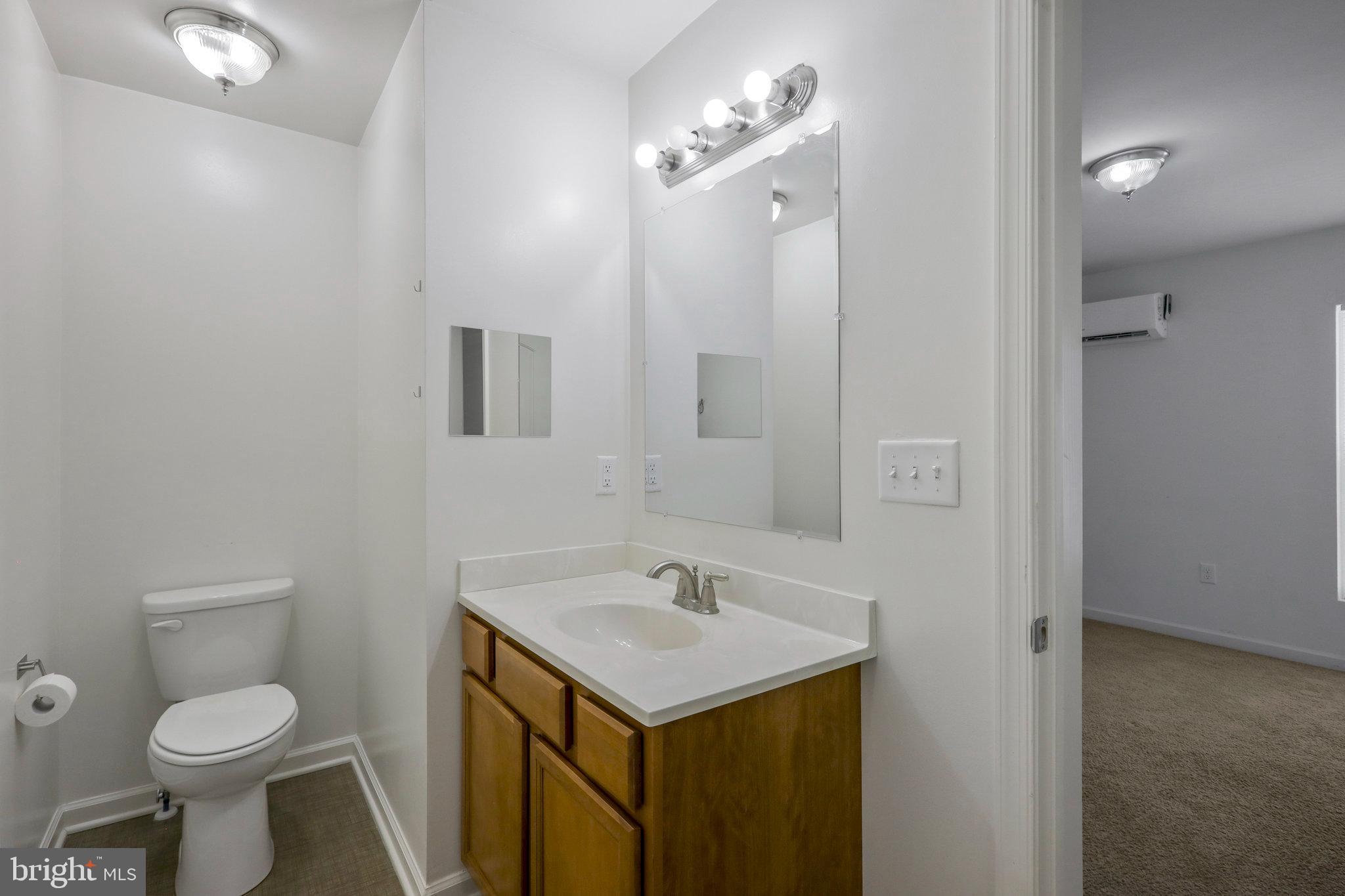 277 4th Avenue, Unit 101 Quantico, VA 22134 - Photo 16 of 29 a bathroom with a sink toilet and a mirror