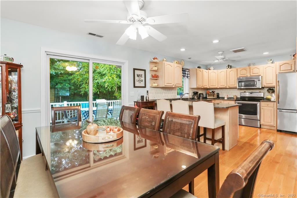Dining Area Opens to Kitchen with granite countertops and stainless appliances.