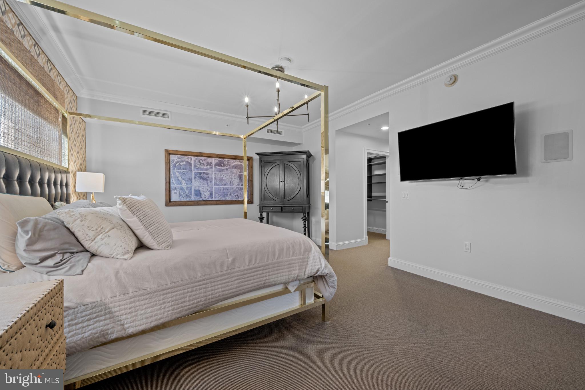 801 Key Highway, Unit 458 Baltimore, MD 21230 - Photo 23 of 48 a bedroom with a bed and a flat screen tv