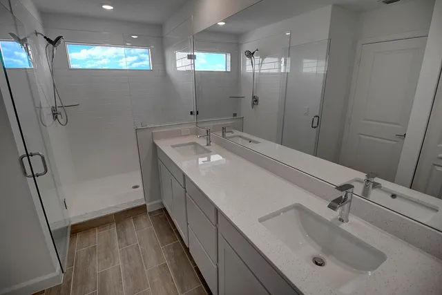 a bathroom with double vanity sink and mirror