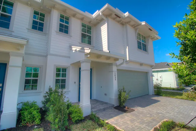 a view of a house with potted plants