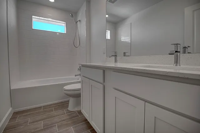 a bathroom with a toilet a sink and bathtub