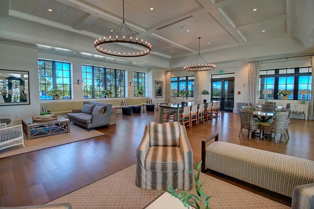 a living room with furniture fireplace and a large window
