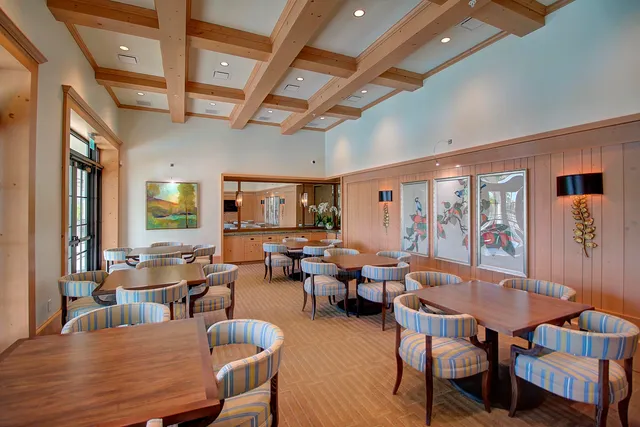 a dining room with furniture window and wooden floor