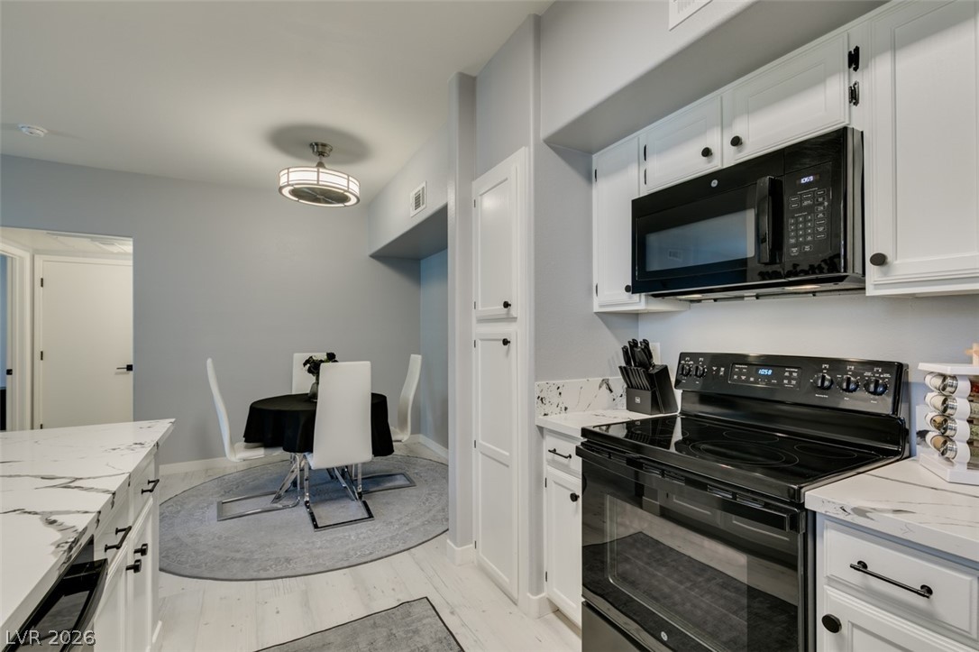 7255 West Sunset Road, Unit 1103 Las Vegas, NV 89113 - Photo 29 of 35 White cabinetry, sleek countertops, and modern appliances outfit this contemporary culinary space.
