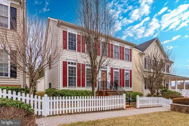 a front view of a house with a fence