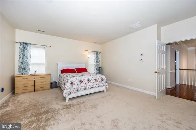 a bedroom with a bed dresser and a window