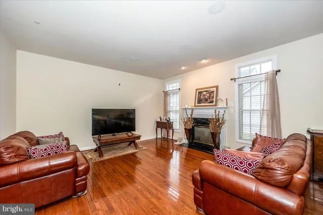 a living room with furniture flat screen tv and a fireplace