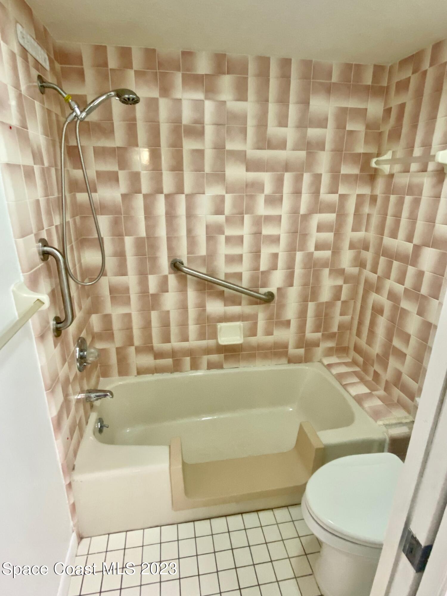 1850 Quail Trail Melbourne, FL 32935 - Photo 11 of 23 a bathroom with a toilet and a shower curtain