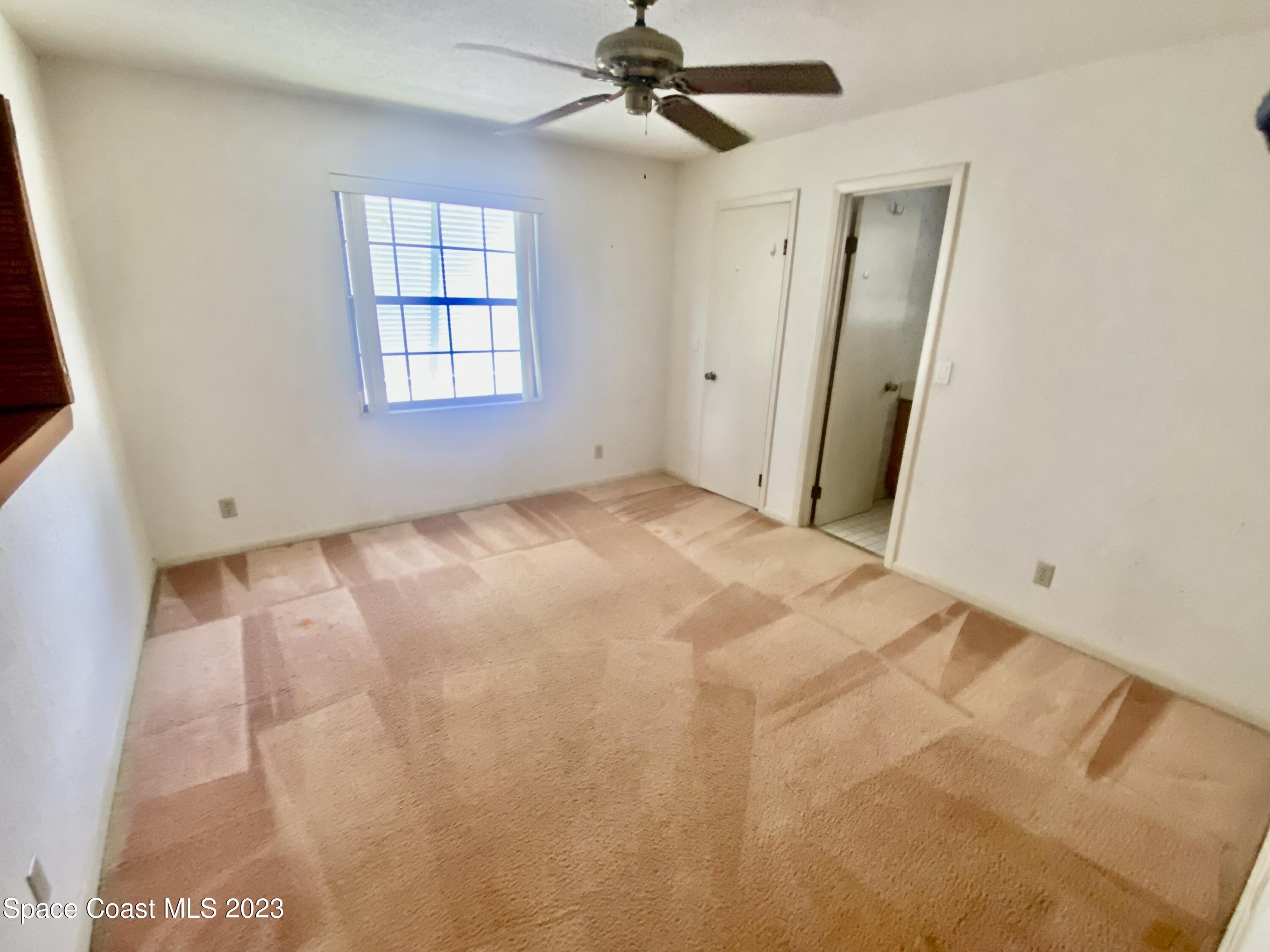 1850 Quail Trail Melbourne, FL 32935 - Photo 16 of 23 an empty room with windows and fan