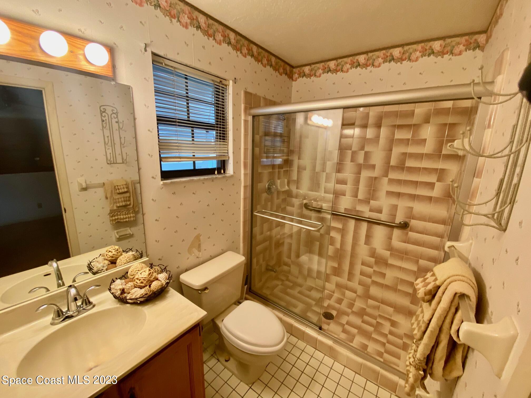 1850 Quail Trail Melbourne, FL 32935 - Photo 17 of 23 a bathroom with a sink toilet and shower