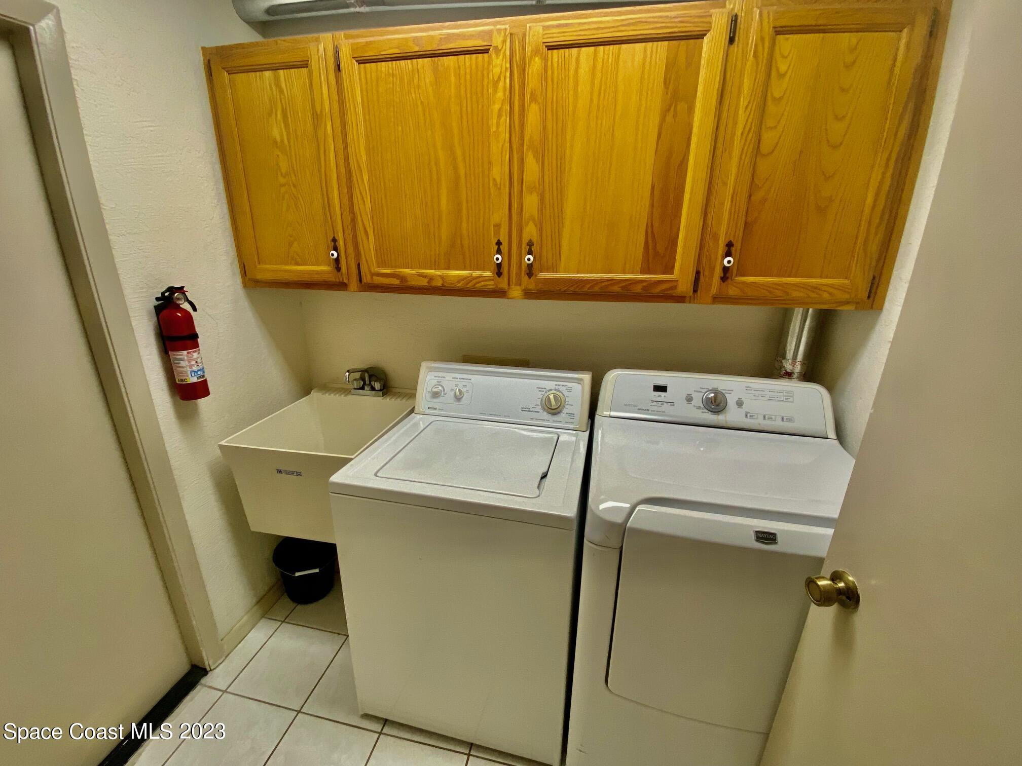 1850 Quail Trail Melbourne, FL 32935 - Photo 18 of 23 a utility room with dryer and washer