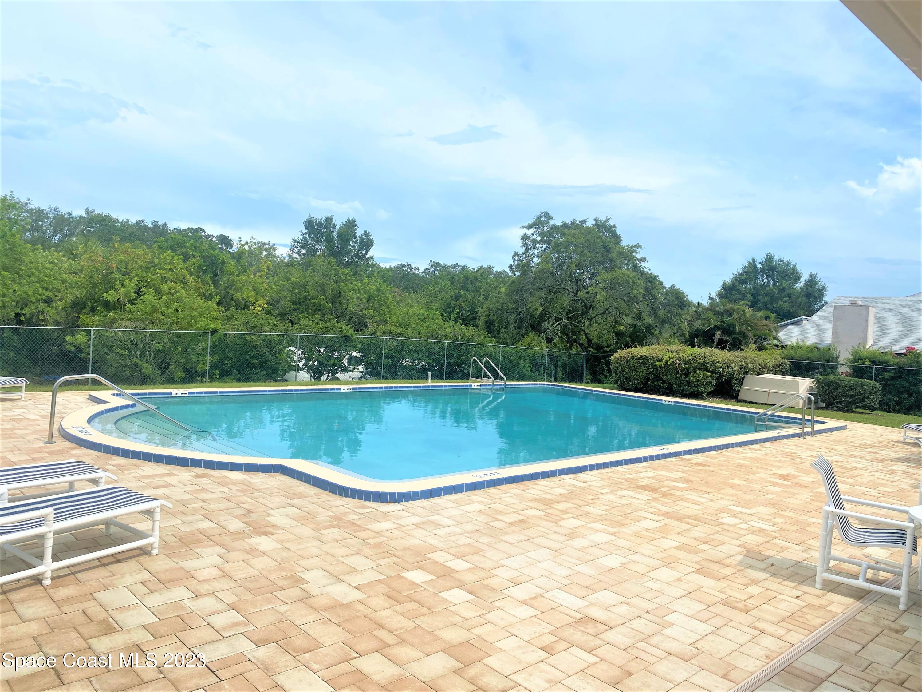1850 Quail Trail Melbourne, FL 32935 - Photo 20 of 23 a view of a swimming pool and a yard