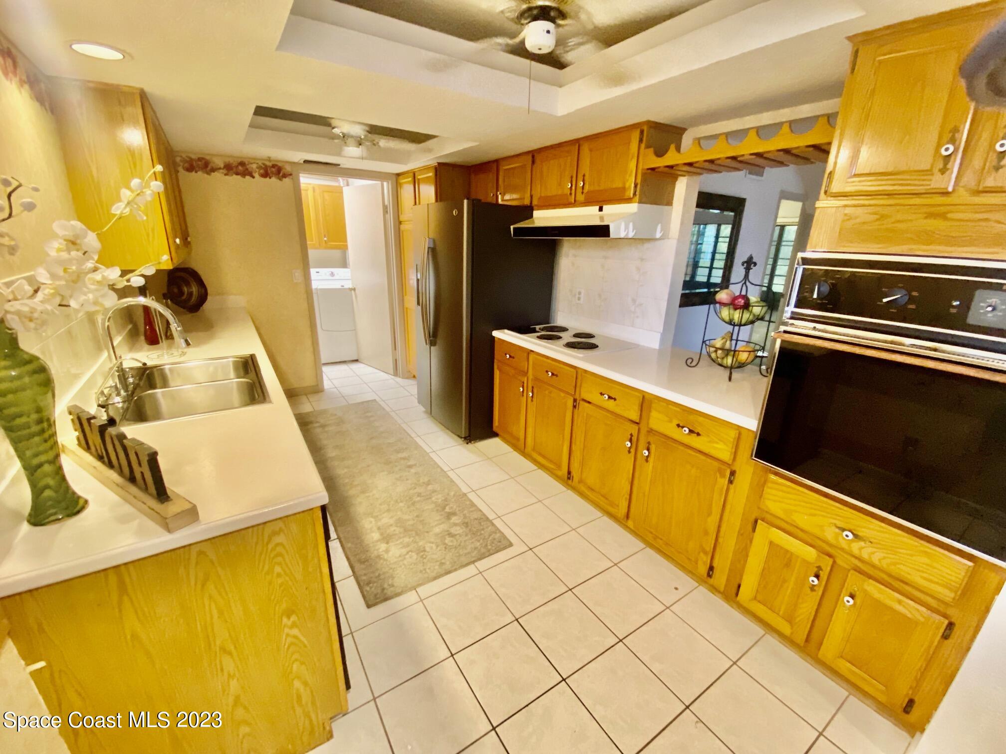 1850 Quail Trail Melbourne, FL 32935 - Photo 2 of 23 a kitchen with a sink appliances and cabinets