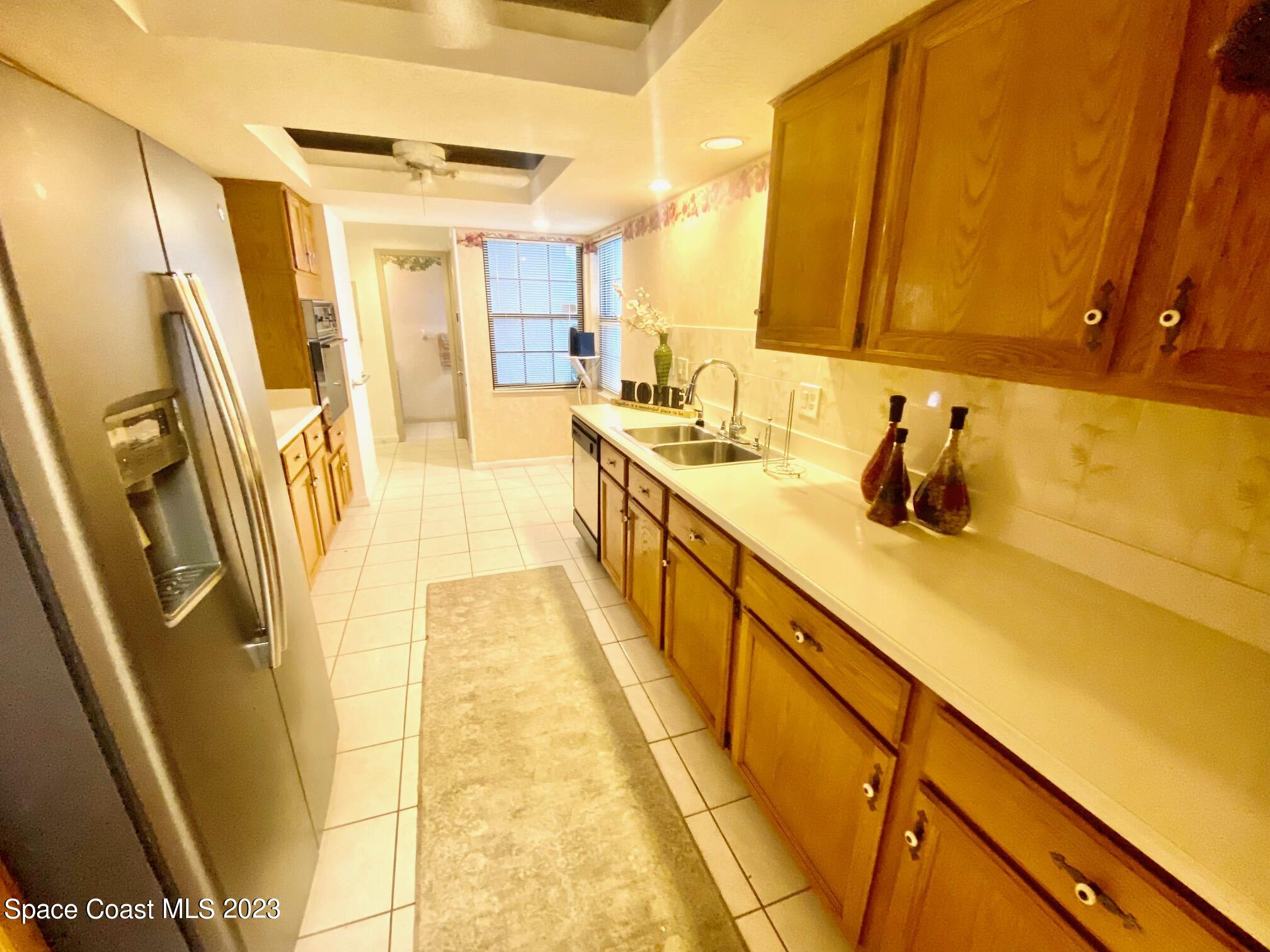 1850 Quail Trail Melbourne, FL 32935 - Photo 3 of 23 a bathroom with a sink a mirror and a shower