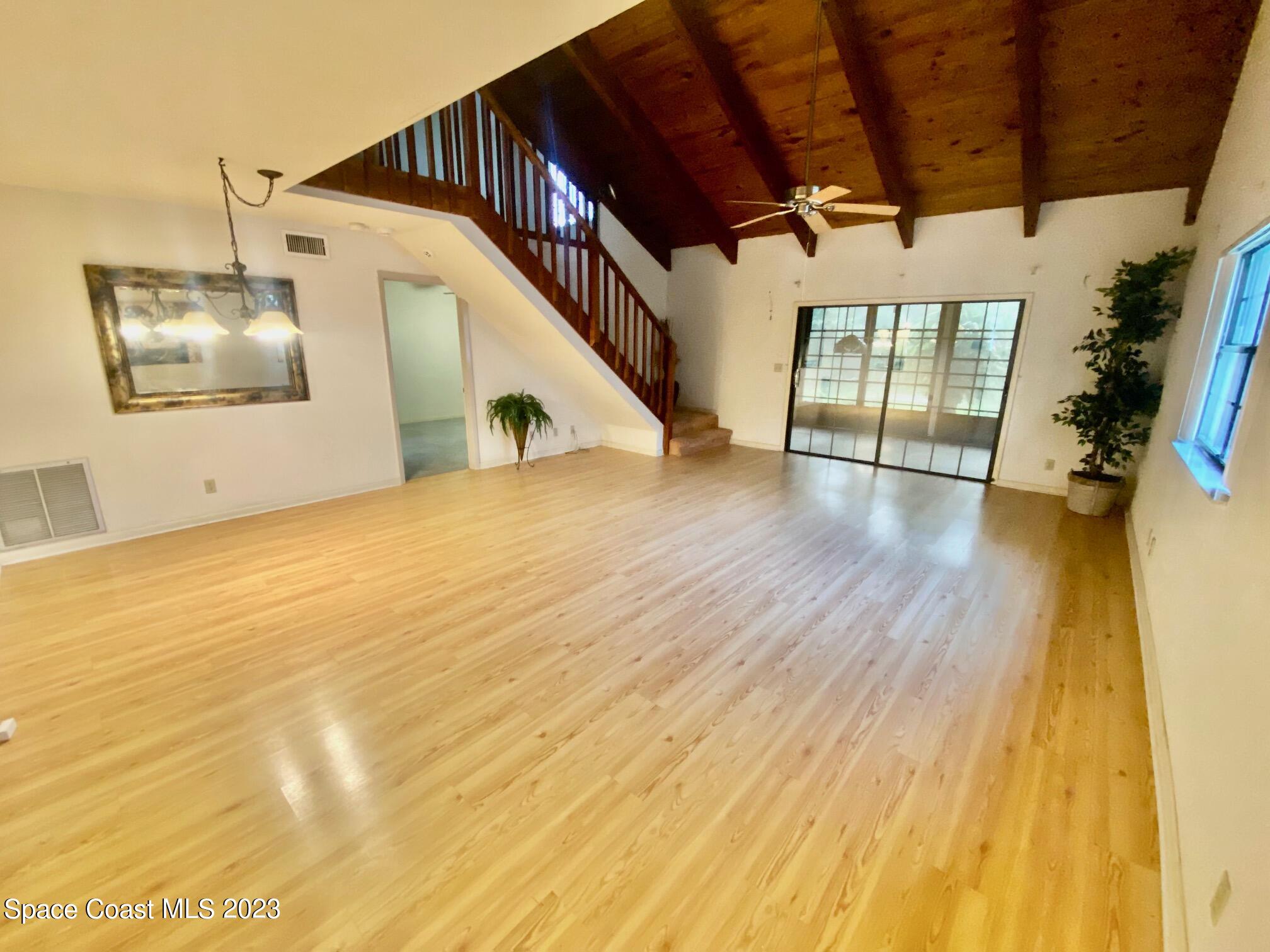 1850 Quail Trail Melbourne, FL 32935 - Photo 4 of 23 a view of a big room with wooden floor and windows