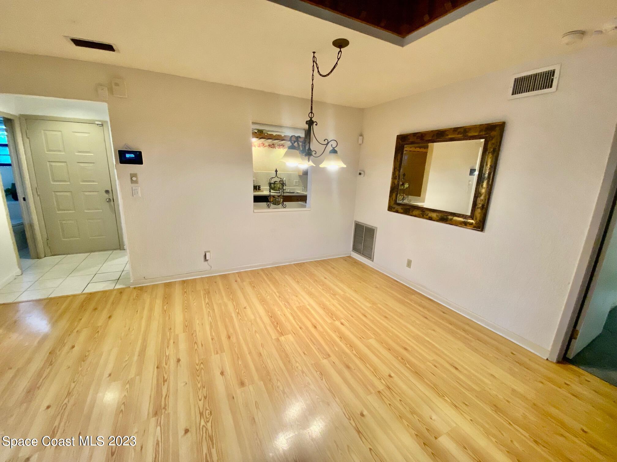 1850 Quail Trail Melbourne, FL 32935 - Photo 6 of 23 a view of a room with wooden floor and windows