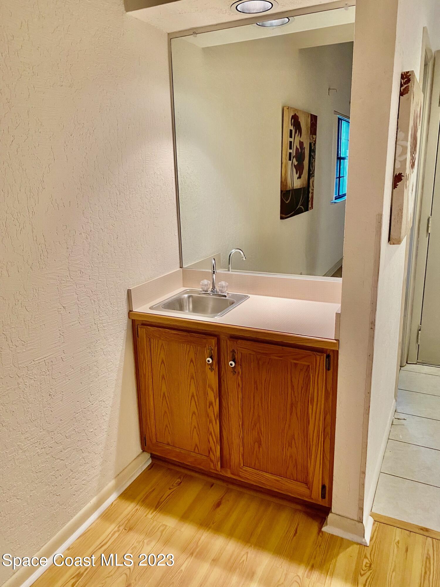 1850 Quail Trail Melbourne, FL 32935 - Photo 7 of 23 a bathroom with a sink and a mirror