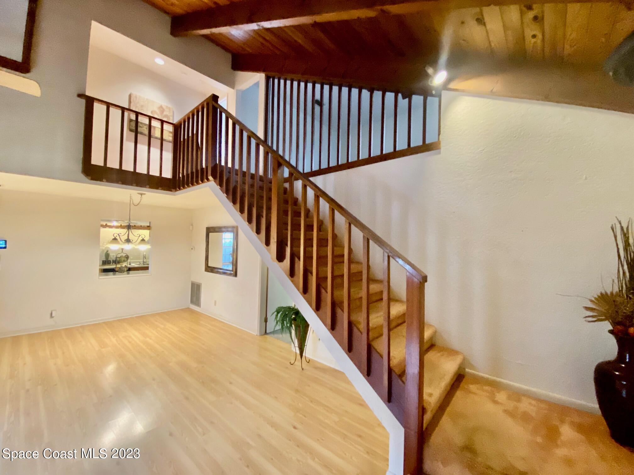 1850 Quail Trail Melbourne, FL 32935 - Photo 8 of 23 a view of staircase with railing and a rug