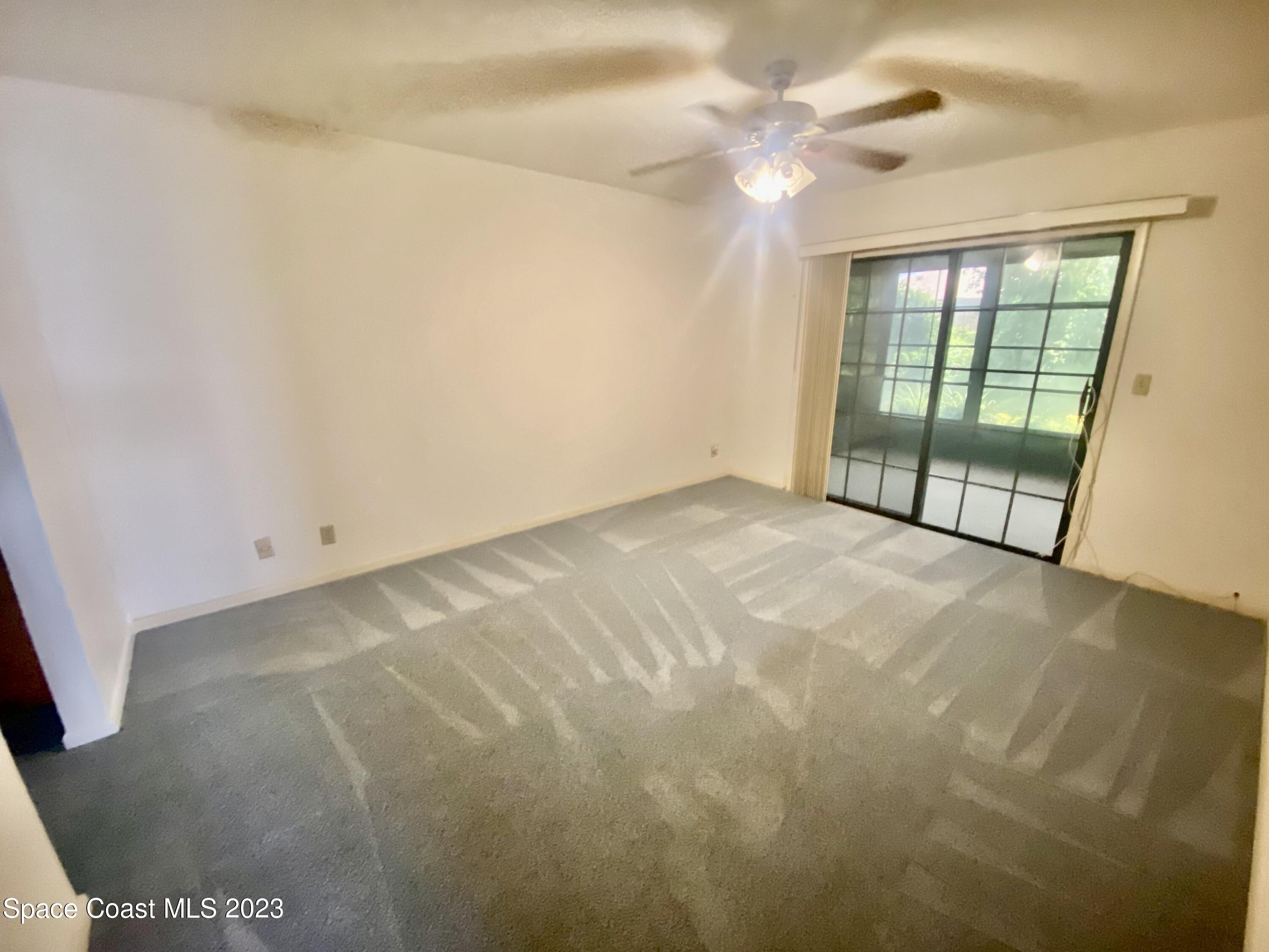 1850 Quail Trail Melbourne, FL 32935 - Photo 9 of 23 a view of an empty room with a window