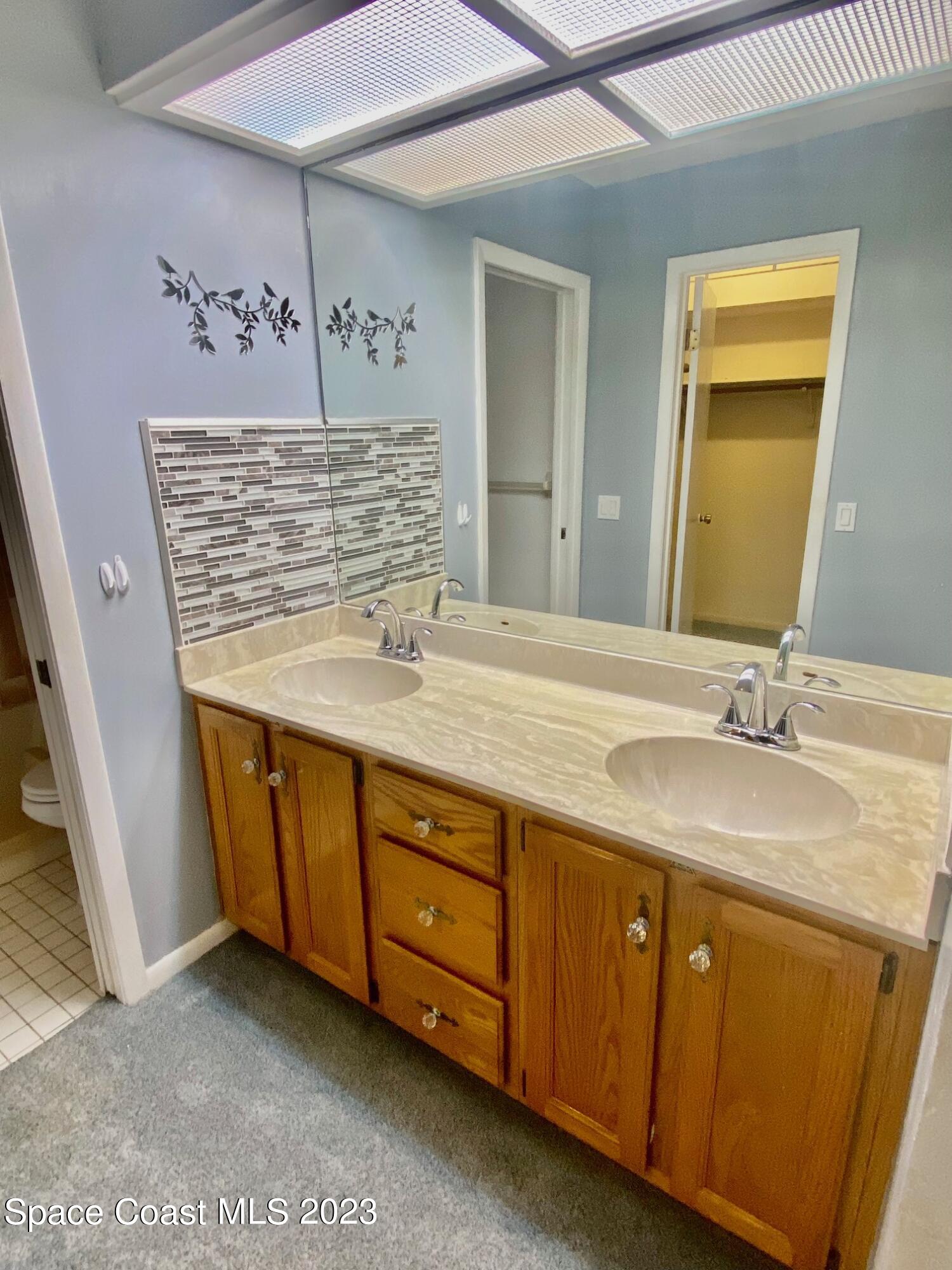 1850 Quail Trail Melbourne, FL 32935 - Photo 10 of 23 a bathroom with a sink a vanity and a mirror