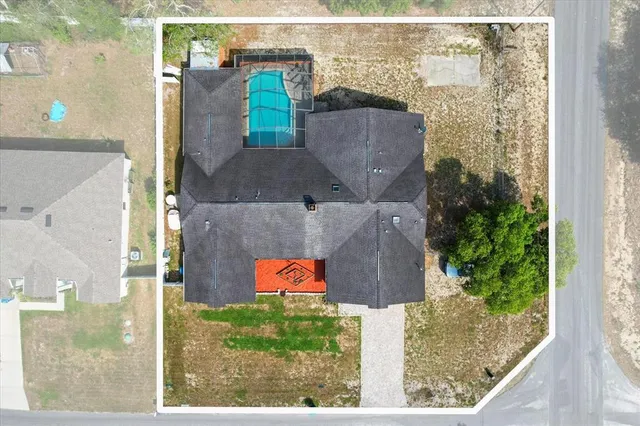 aerial view of a house with outdoor space and street view