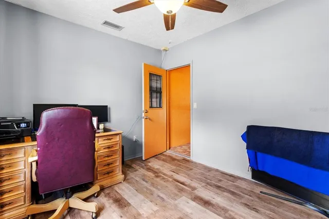 a view of a workspace with furniture and a window