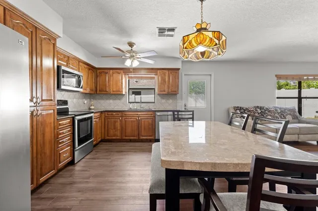 a living room with furniture and kitchen view