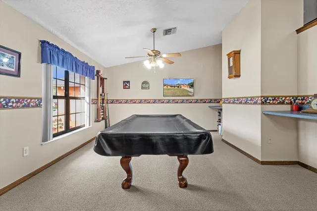 a kitchen with granite countertop a refrigerator a sink and dishwasher
