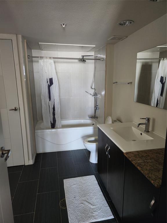 1100 West Trinity Mills Road, Unit 2013 Carrollton, TX 75006 - Photo 15 of 15 a bathroom with a sink a mirror and a shower