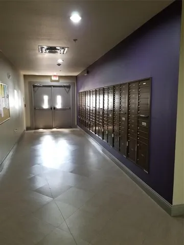 a view of parking garage with cars parked