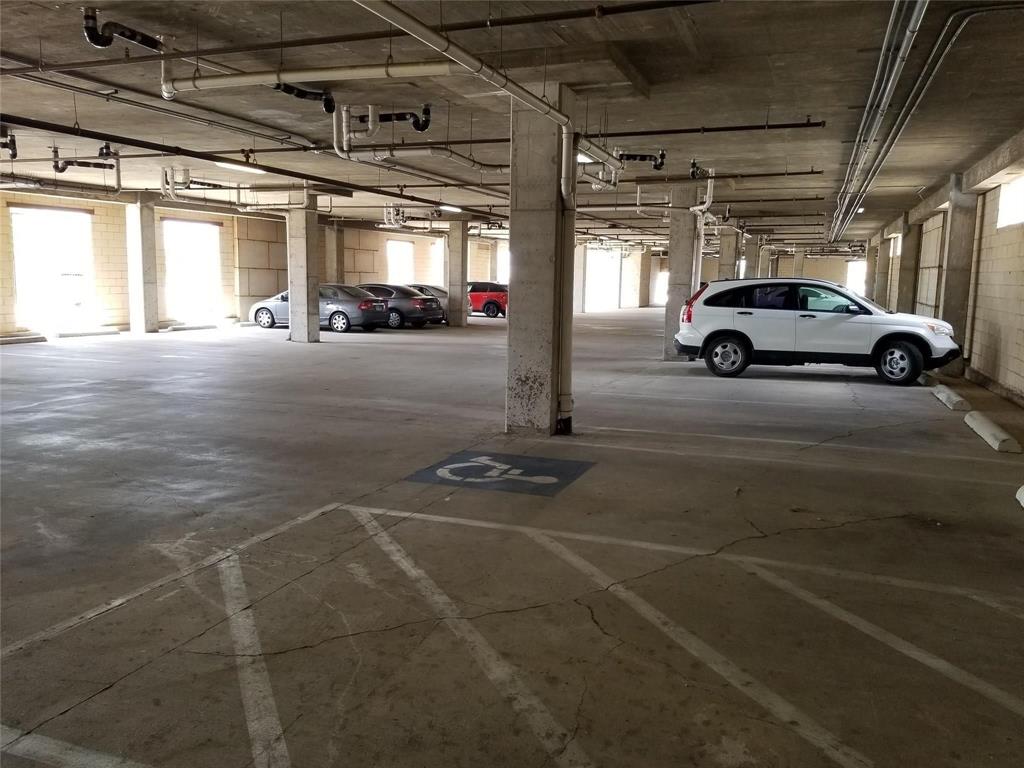 1100 West Trinity Mills Road, Unit 2013 Carrollton, TX 75006 - Photo 6 of 15 a view of parking garage with cars parked