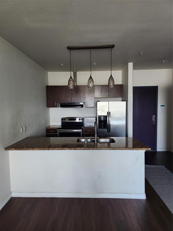 1100 West Trinity Mills Road, Unit 2013 Carrollton, TX 75006 - Photo 10 of 15 a kitchen with kitchen island stainless steel appliances a sink and counter space