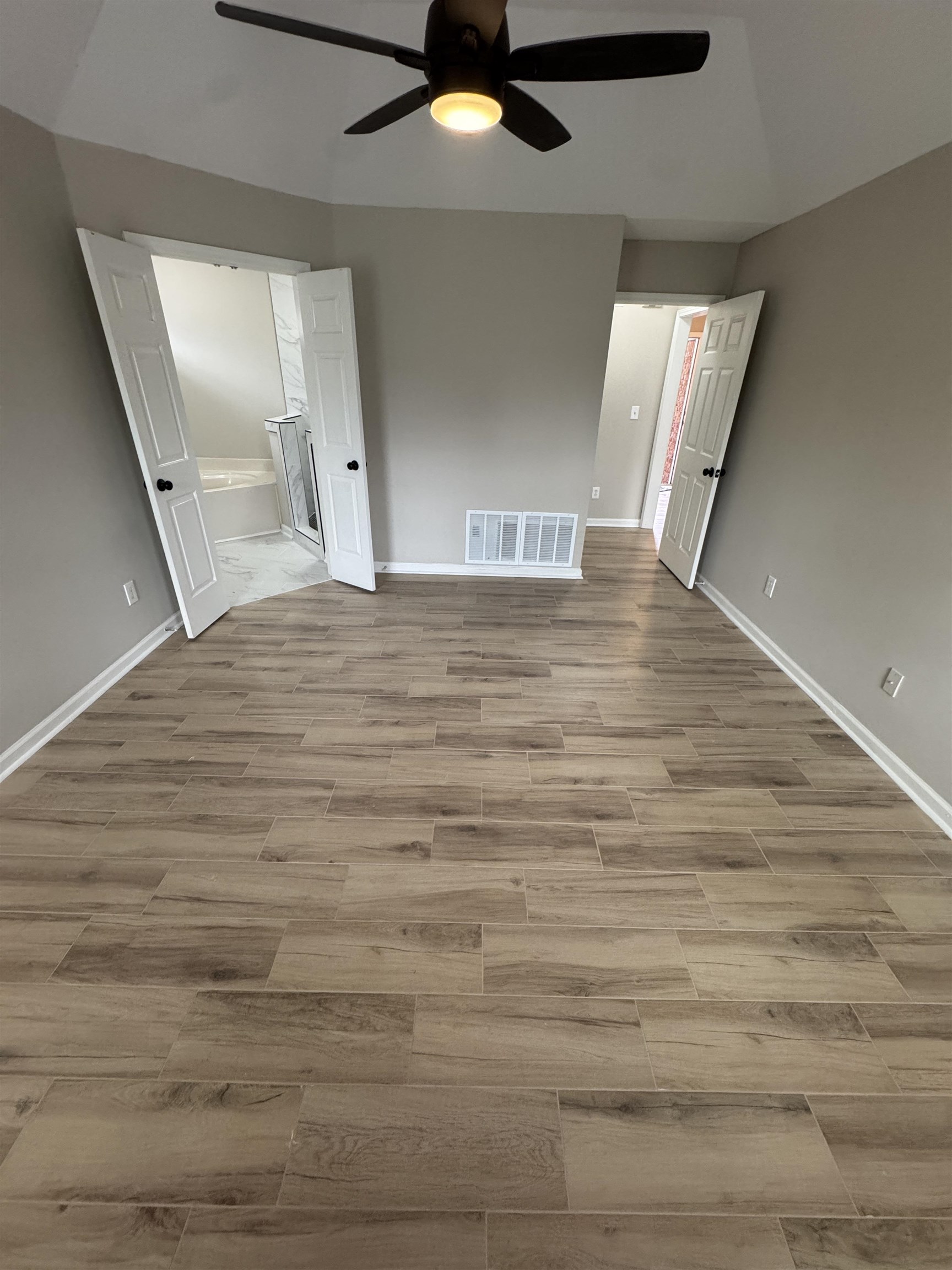 5457 Sundale Way South Memphis, TN 38135 - Photo 11 of 23 Unfurnished bedroom featuring wood tiled floors, a ceiling fan, and lofted ceiling