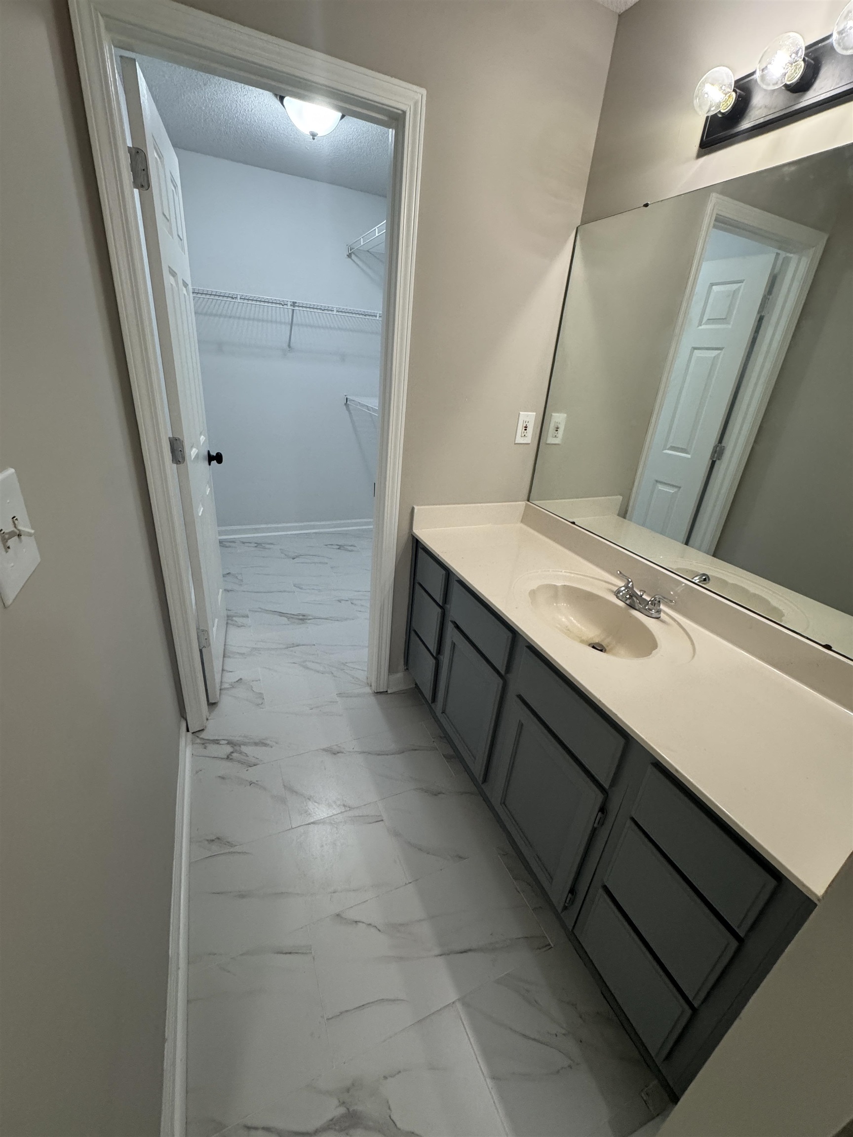 5457 Sundale Way South Memphis, TN 38135 - Photo 13 of 23 Bathroom featuring light marble finish floors, vanity, and a spacious closet