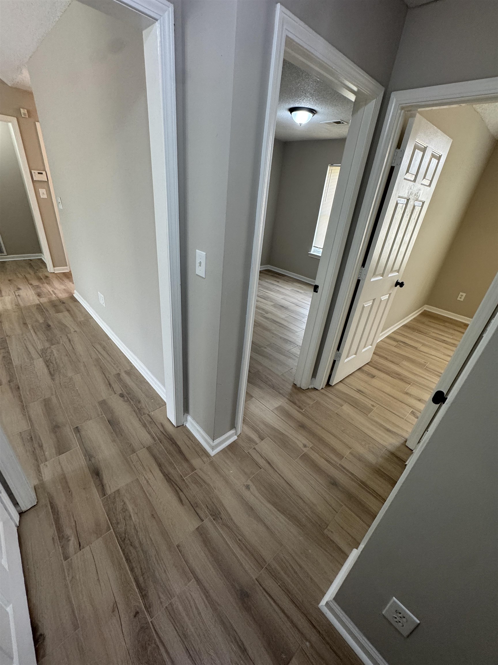 5457 Sundale Way South Memphis, TN 38135 - Photo 14 of 23 Corridor with light wood-type flooring and a textured ceiling