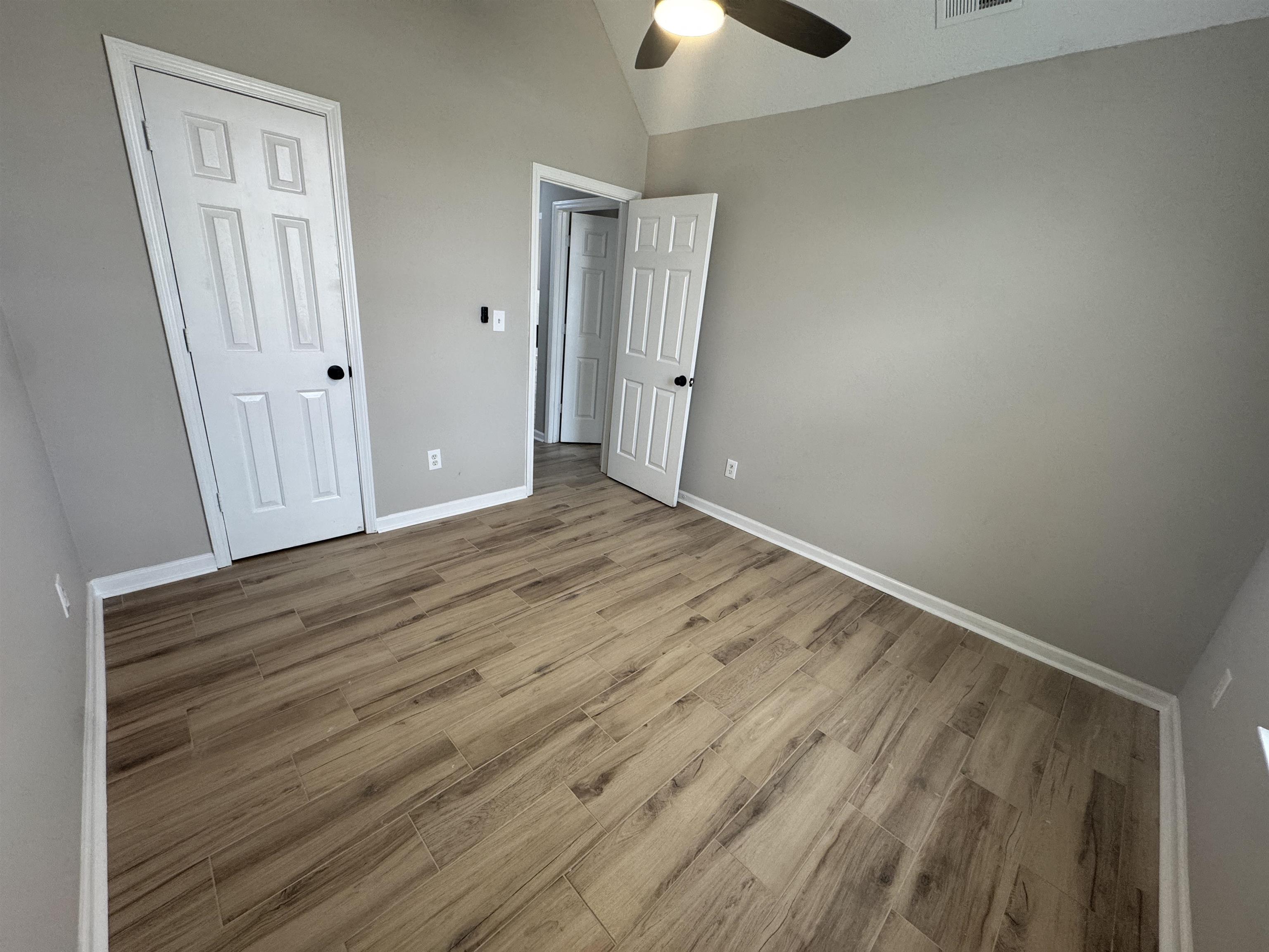 5457 Sundale Way South Memphis, TN 38135 - Photo 20 of 23 Unfurnished bedroom with lofted ceiling, light wood finished floors, and a ceiling fan