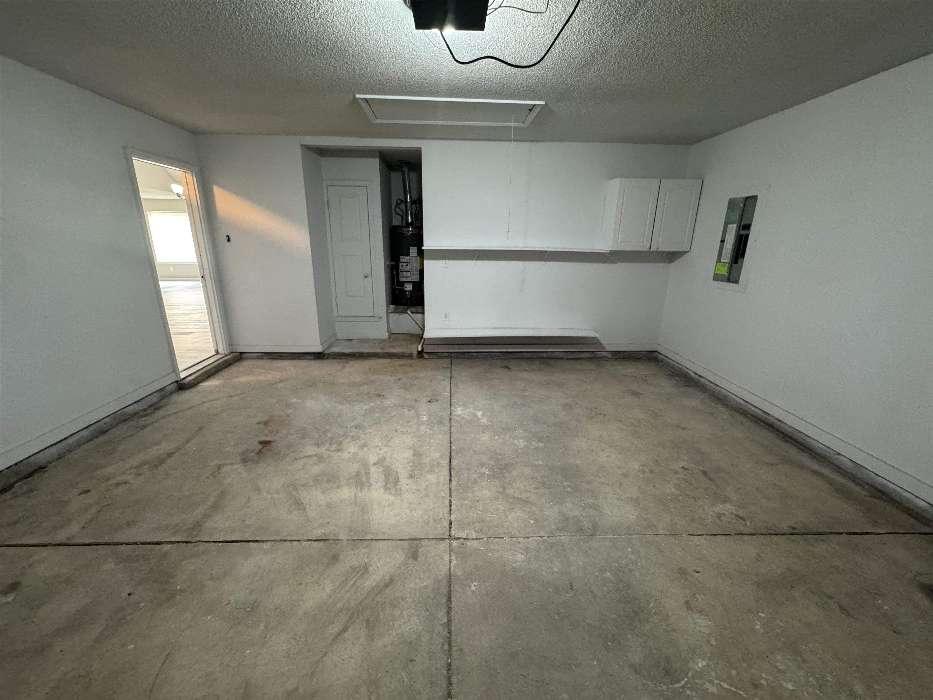 5457 Sundale Way South Memphis, TN 38135 - Photo 22 of 23 Garage featuring electric panel, a garage door opener, and gas water heater
