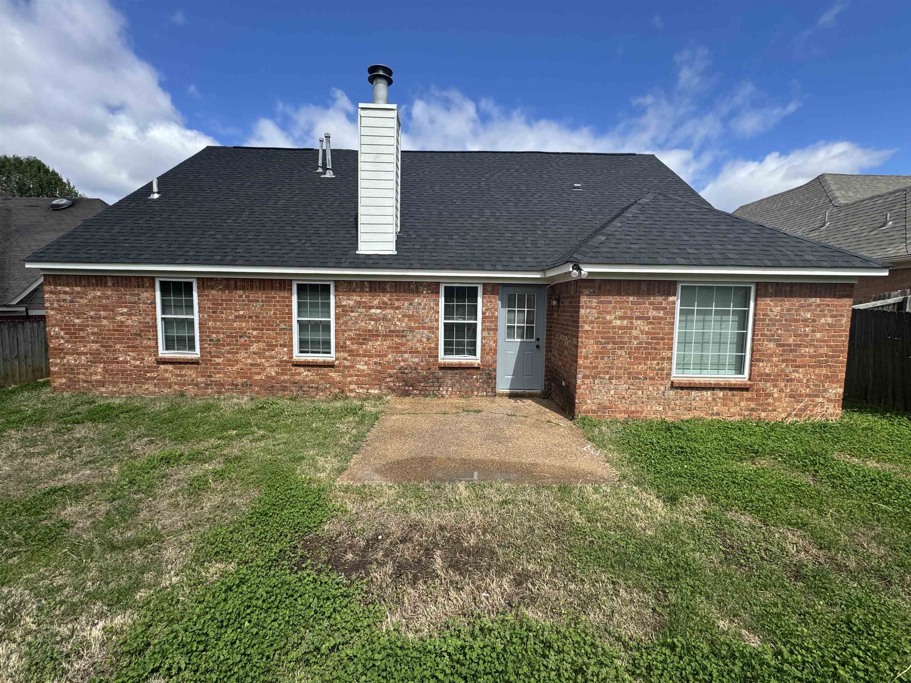 5457 Sundale Way South Memphis, TN 38135 - Photo 23 of 23 Back of property with a patio area, a chimney, a fenced backyard, and brick siding