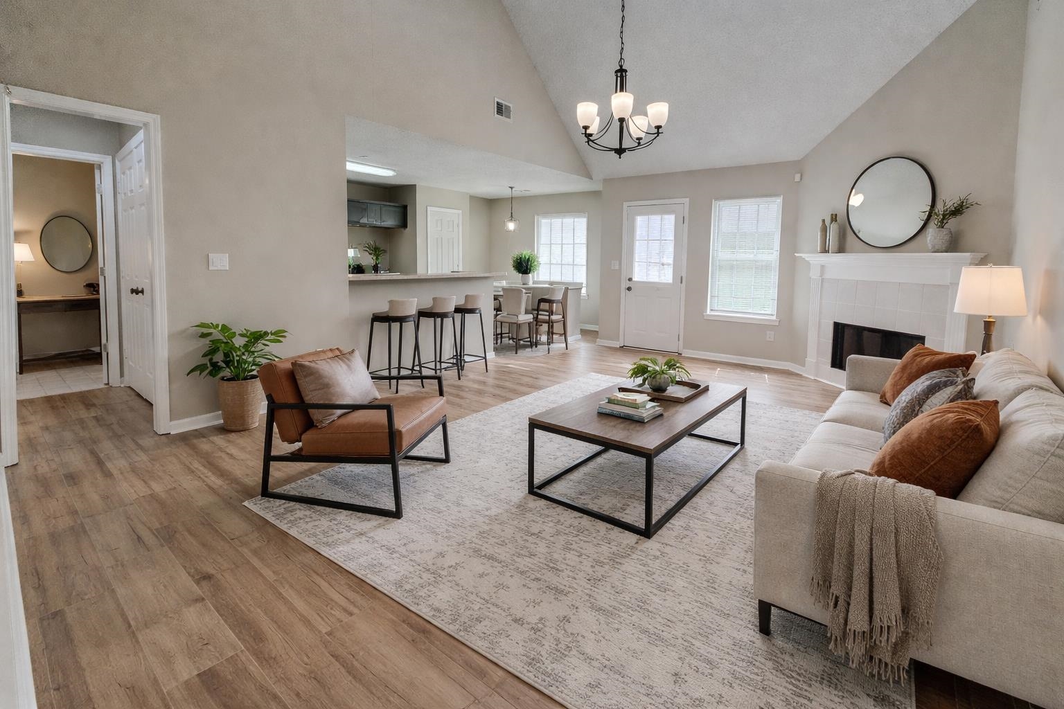 5457 Sundale Way South Memphis, TN 38135 - Photo 3 of 23 Living area with light wood finished floors, vaulted ceiling, a tiled fireplace, and suspended lighting