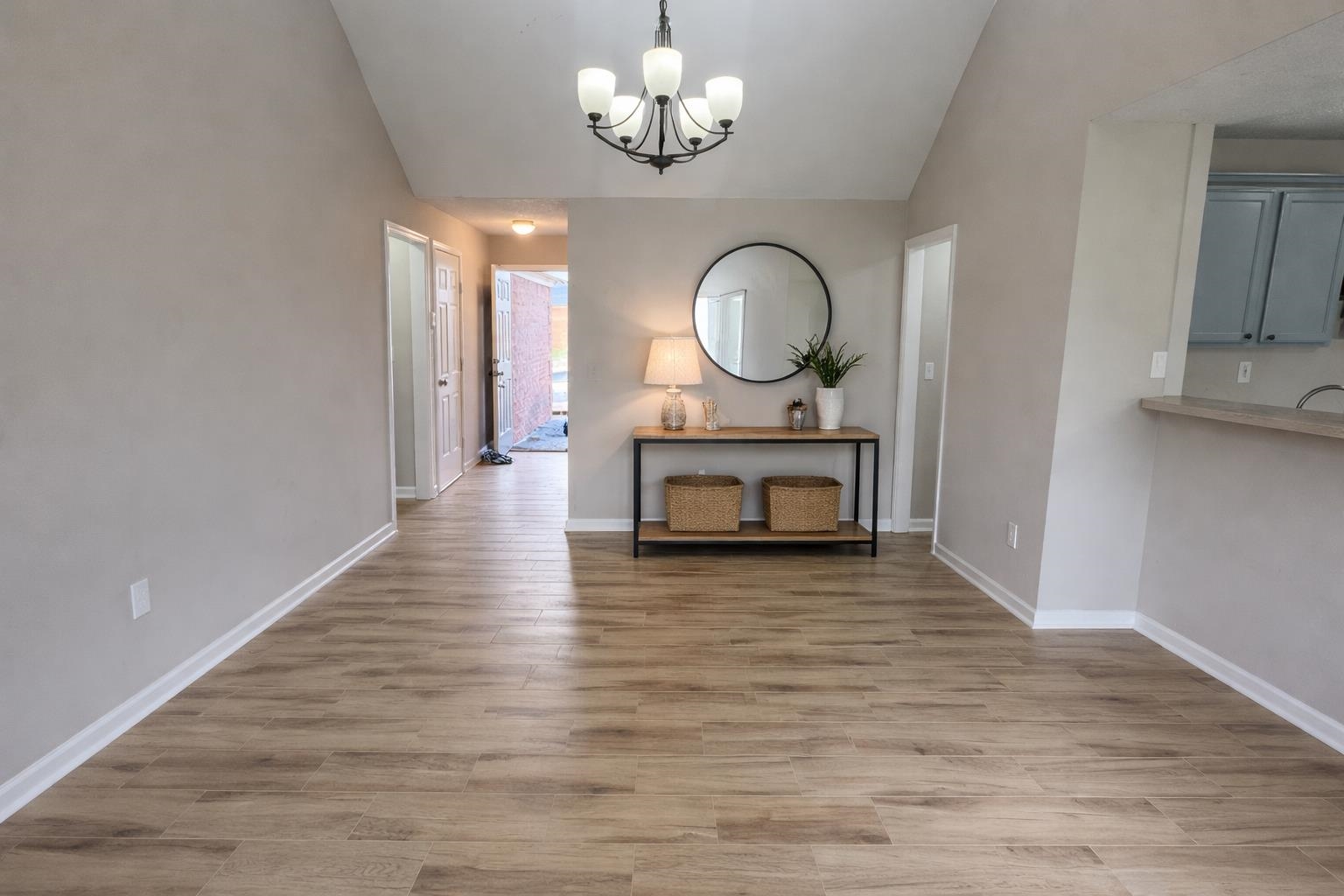 5457 Sundale Way South Memphis, TN 38135 - Photo 6 of 23 Unfurnished dining area featuring vaulted ceiling, light wood-style flooring, and suspended lighting