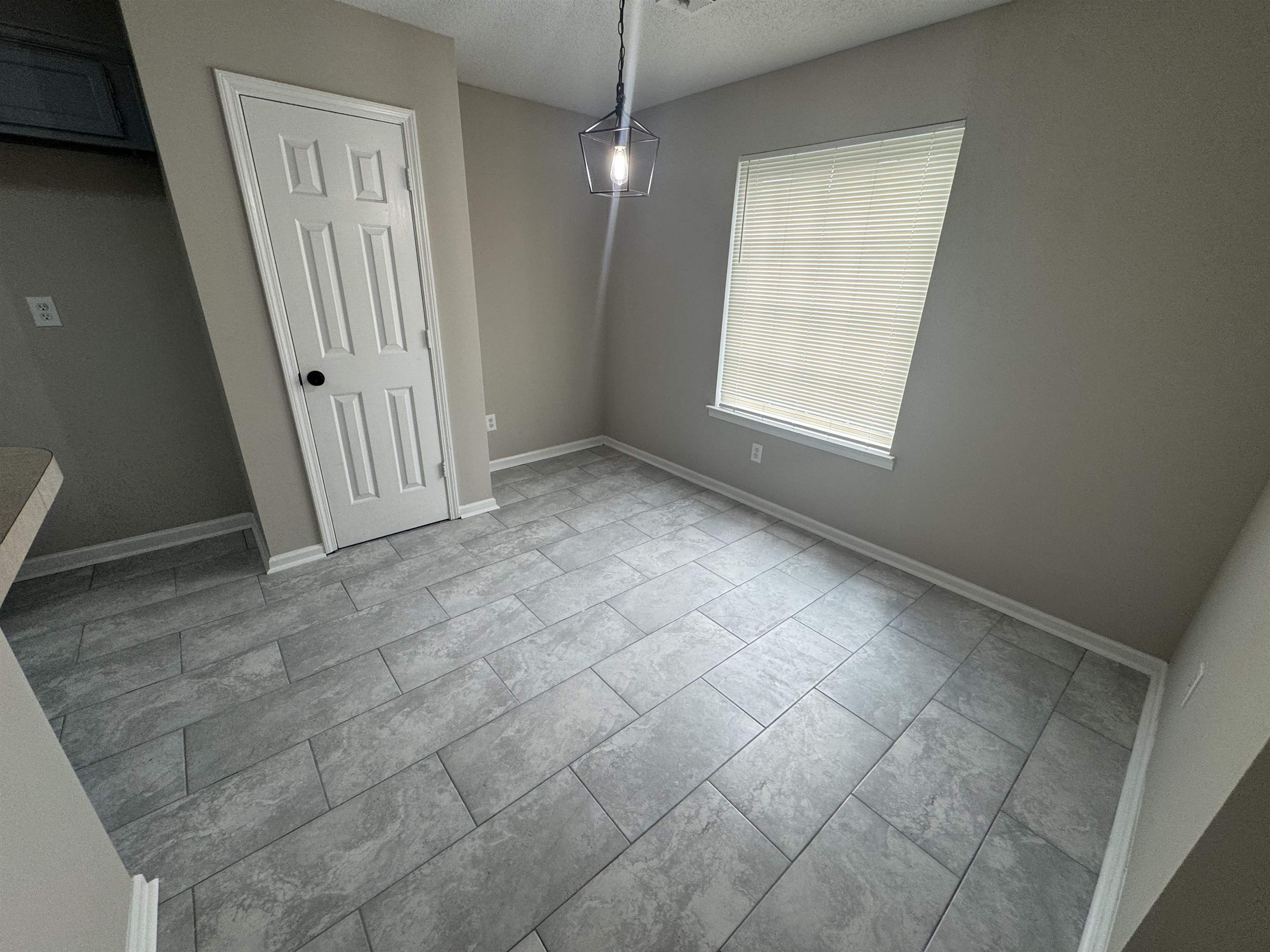 5457 Sundale Way South Memphis, TN 38135 - Photo 9 of 23 Unfurnished dining area featuring baseboards and a textured ceiling