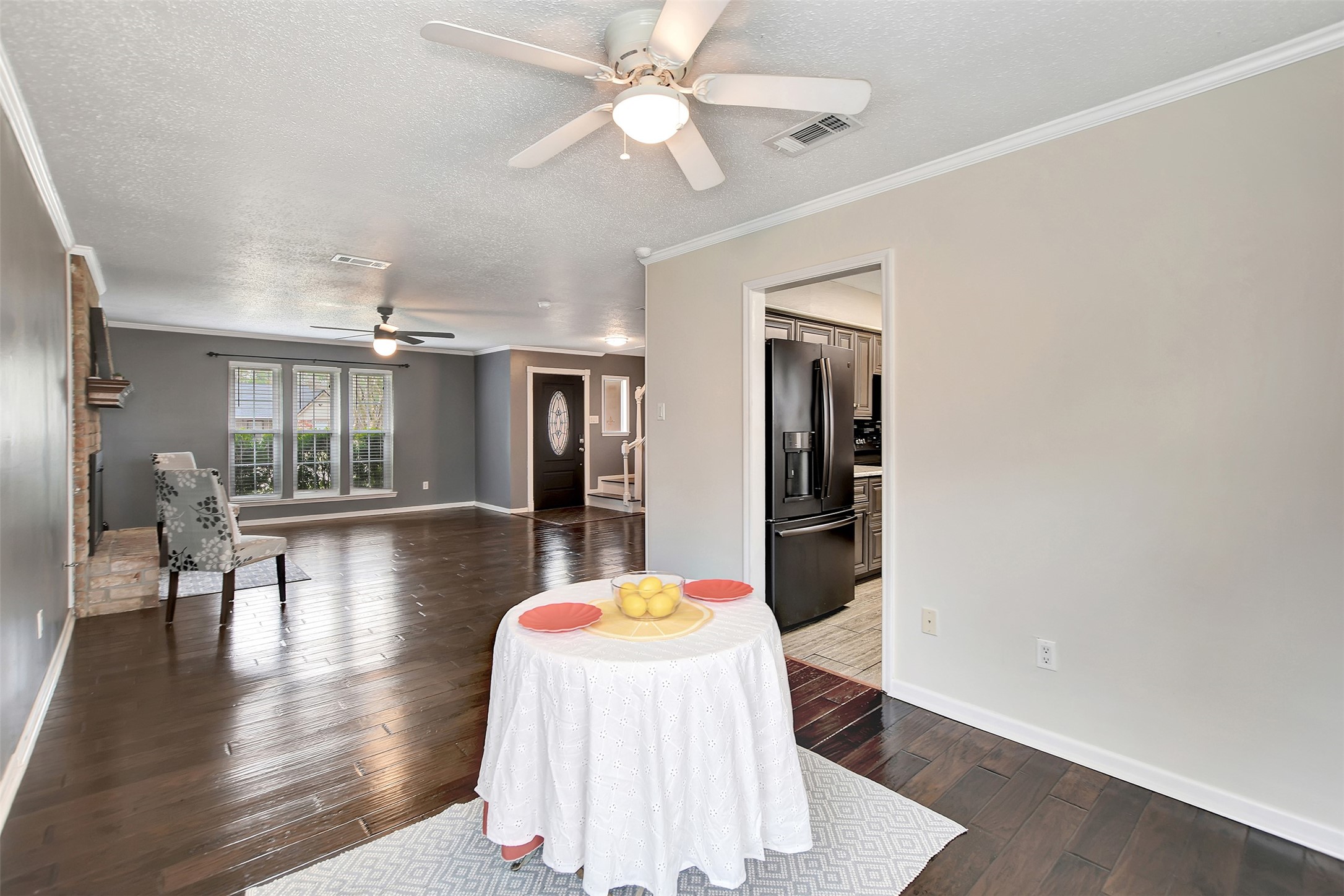 8 Arlington Street Conroe, TX 77301 - Photo 17 of 43 a dining room with wooden floor and chandelier